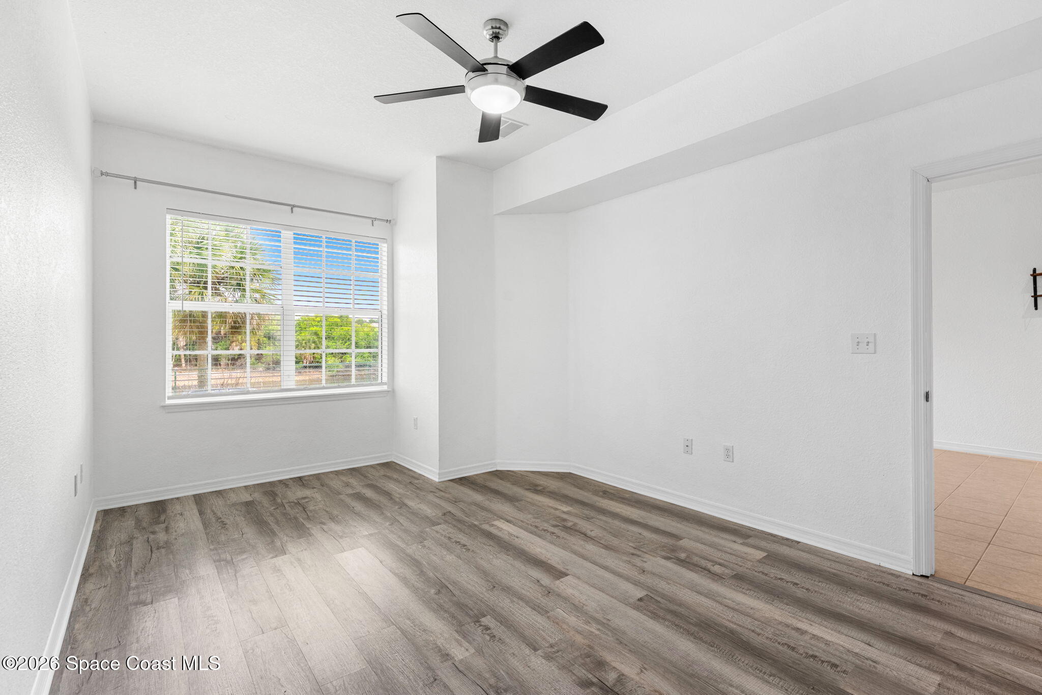 110 Turpial Way, Unit 106 Melbourne, FL 32901 - Photo 21 of 50 wooden floor in an empty room with a window