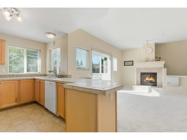 a open kitchen with granite countertop a stove and a sink