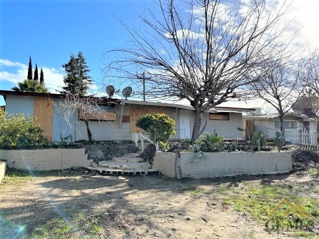 Undisclosed Address Bakersfield, CA 93305 - Photo 2 of 16 a front view of a house with garden
