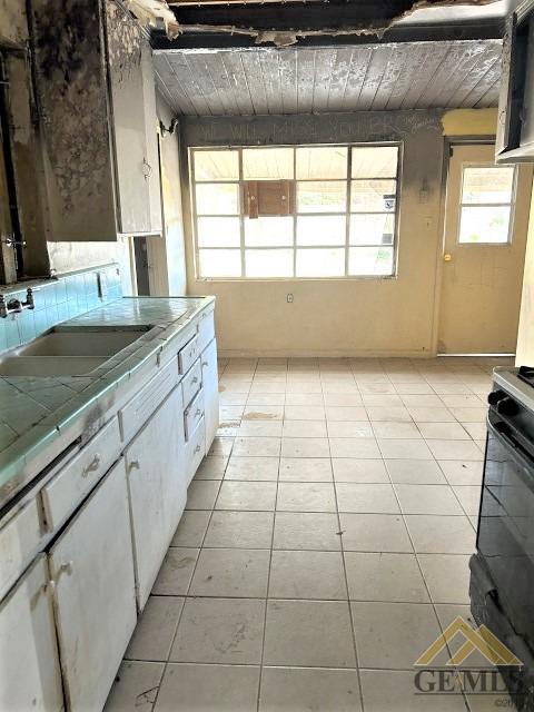 Undisclosed Address Bakersfield, CA 93305 - Photo 4 of 16 a kitchen with a sink a stove and a window
