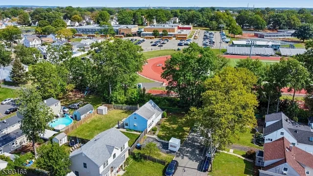 an aerial view of a house with swimming pool outdoor seating and yard view