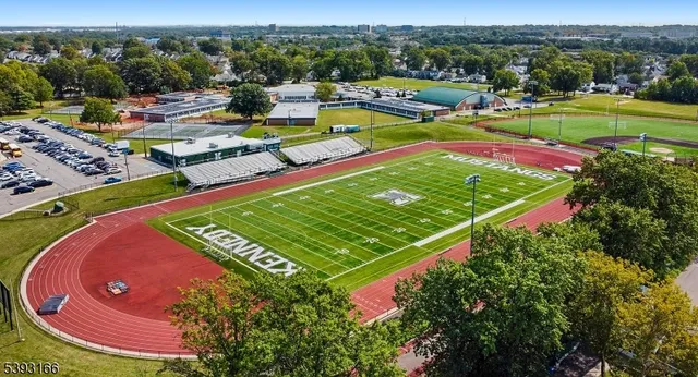 an aerial view of a pool yard and mountain view in back