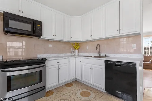 a kitchen with sink cabinets and appliances