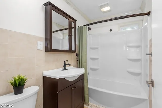 an empty room with a window and a ceiling fan