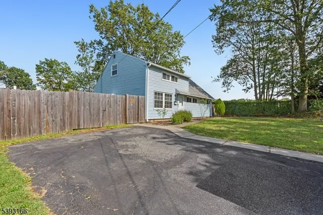a view of a house with a backyard
