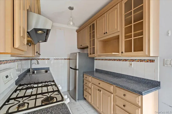 a kitchen with granite countertop a stove and a sink