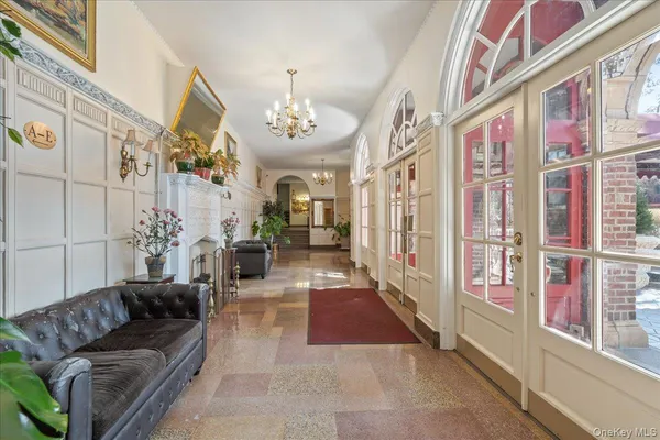 a lobby with furniture and a chandelier