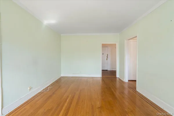 a view of an empty room and wooden floor