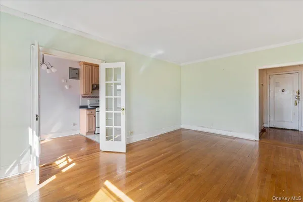 a view of empty room with wooden floor