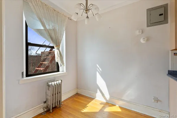 a view of a room with wooden floor and a ceiling fan