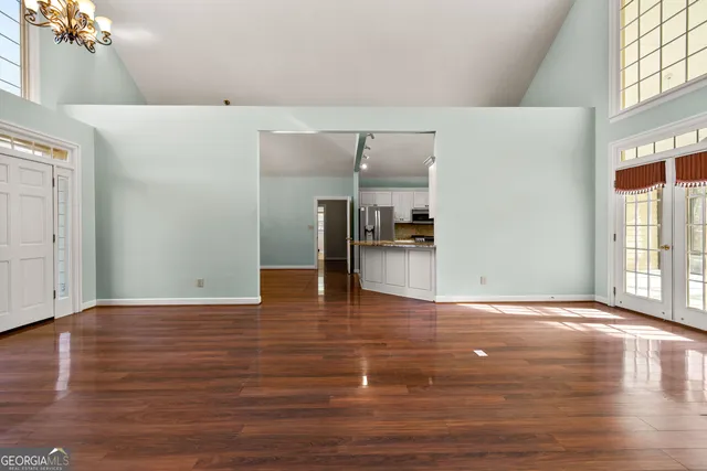 a view of a hallway with wooden floor and closet