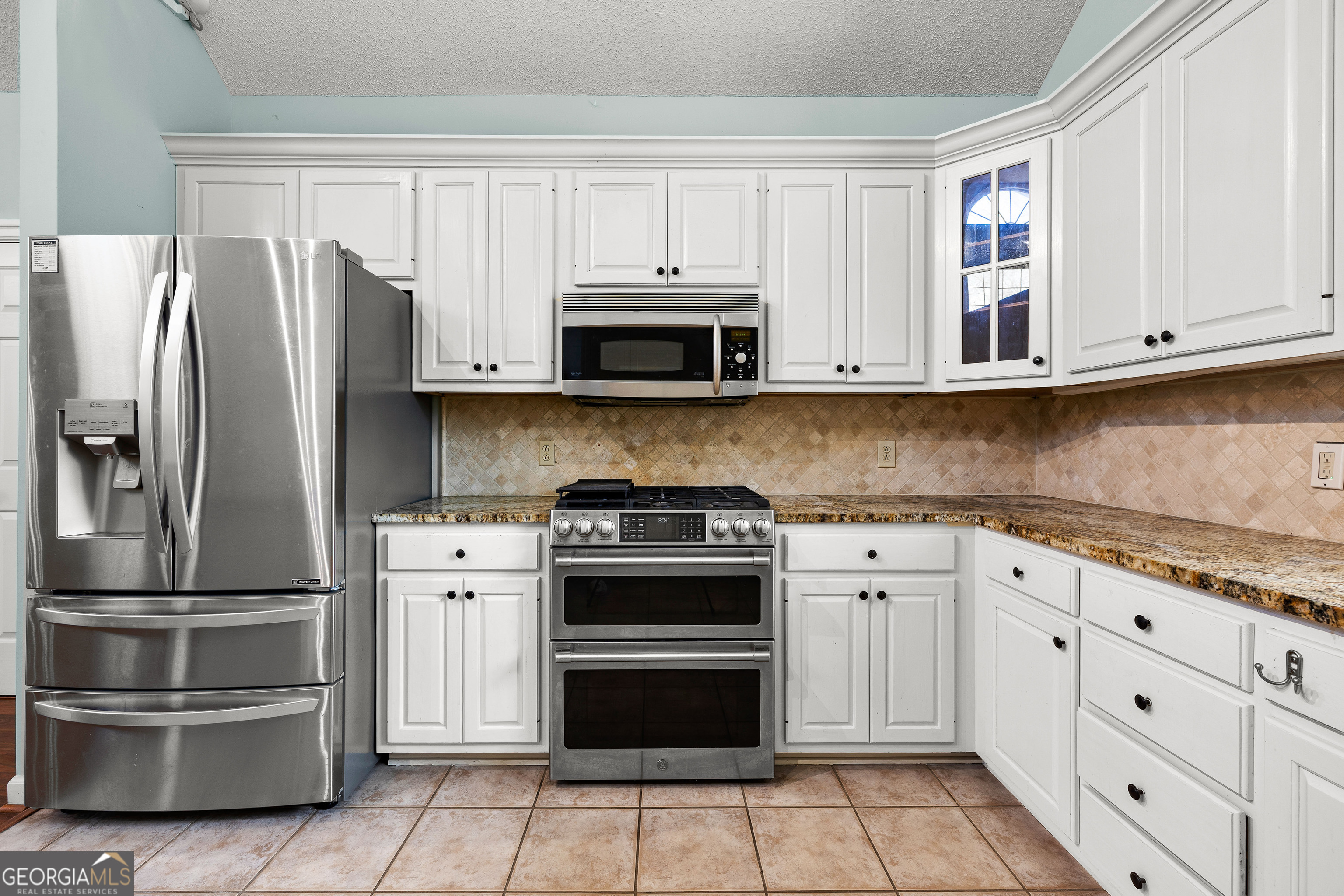 100 Beaver Run Trace Thomaston, GA 30286 - Photo 28 of 78 a kitchen with granite countertop a stainless steel appliances and cabinets