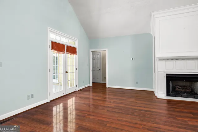 a view of house with yard and trees in the background