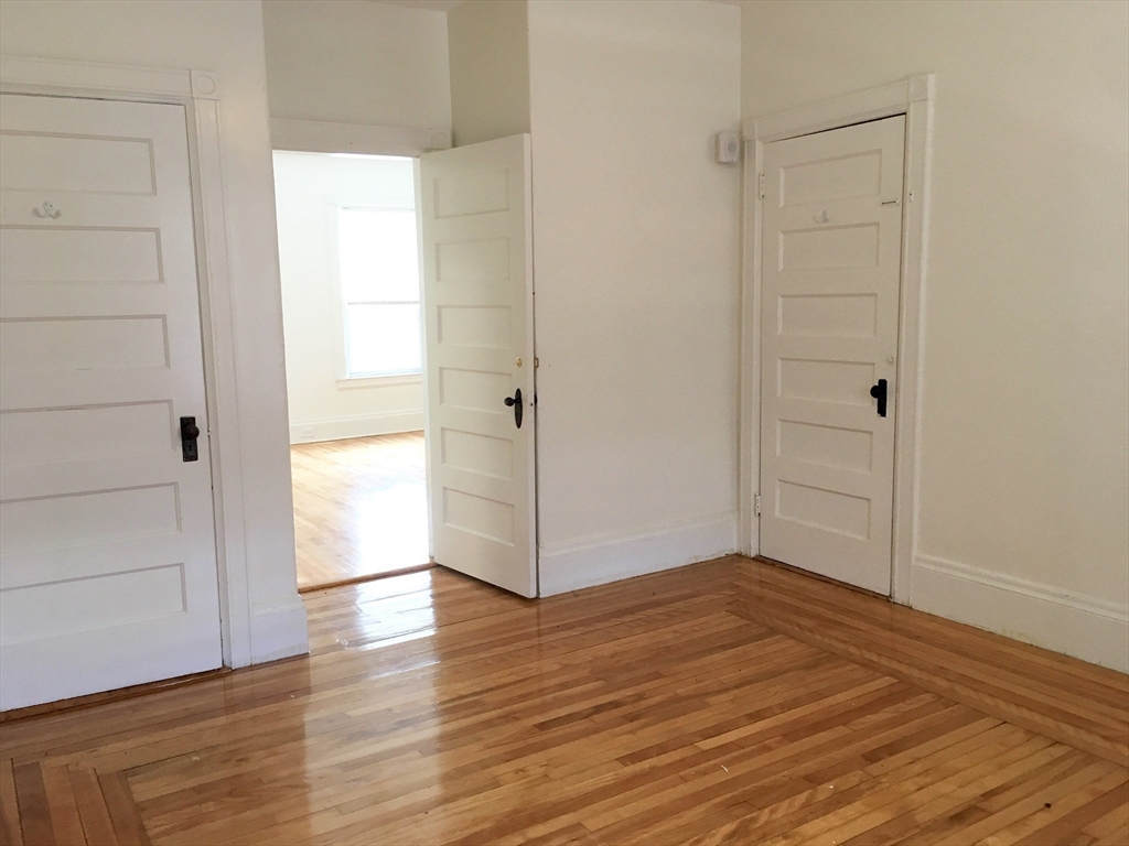 78 Downing Street Worcester, MA 01610 - Photo 7 of 11 wooden floor in an empty room
