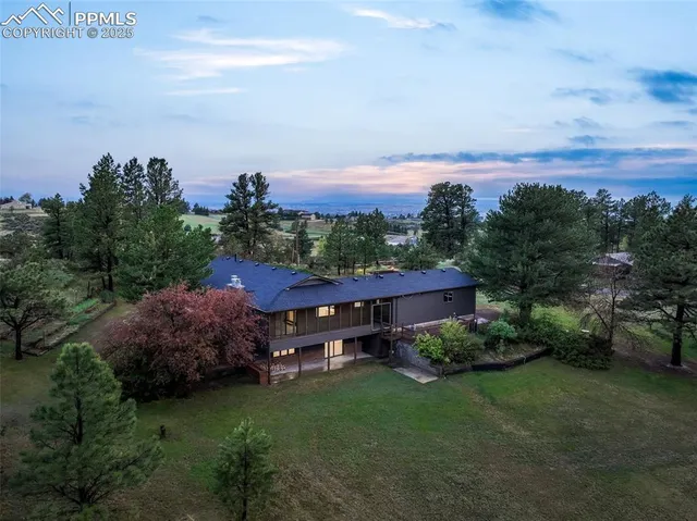 a view of a house with a garden and a yard