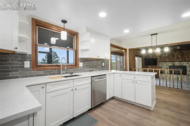 a large white kitchen with a large window