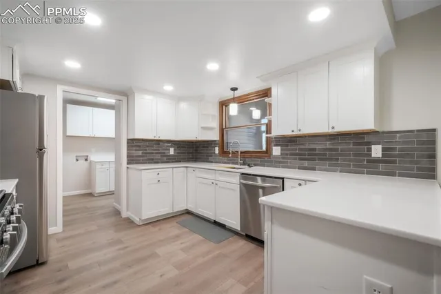 a kitchen with granite countertop white cabinets and white appliances