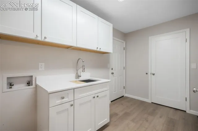 a view of a hallway with wooden floor and door
