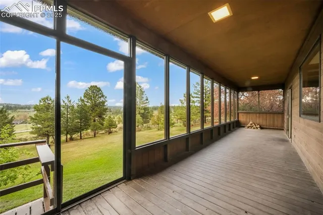 a view of balcony with wooden floor and fence