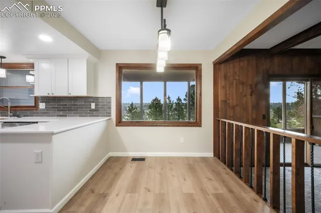 a kitchen with a large window appliances and cabinets