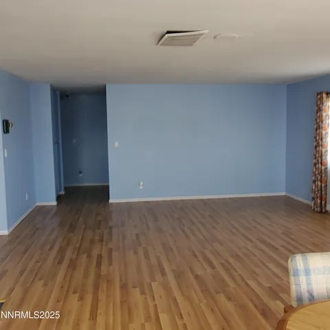 a view of an empty room and wooden floor