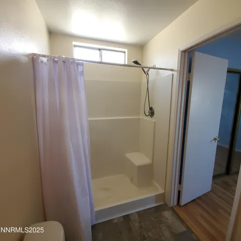 a bathroom with a glass shower door