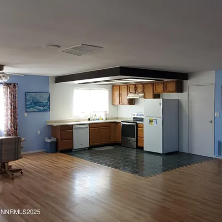 a kitchen with stainless steel appliances kitchen island wooden cabinets and a counter top space