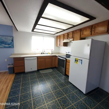 a kitchen with stainless steel appliances and white cabinets