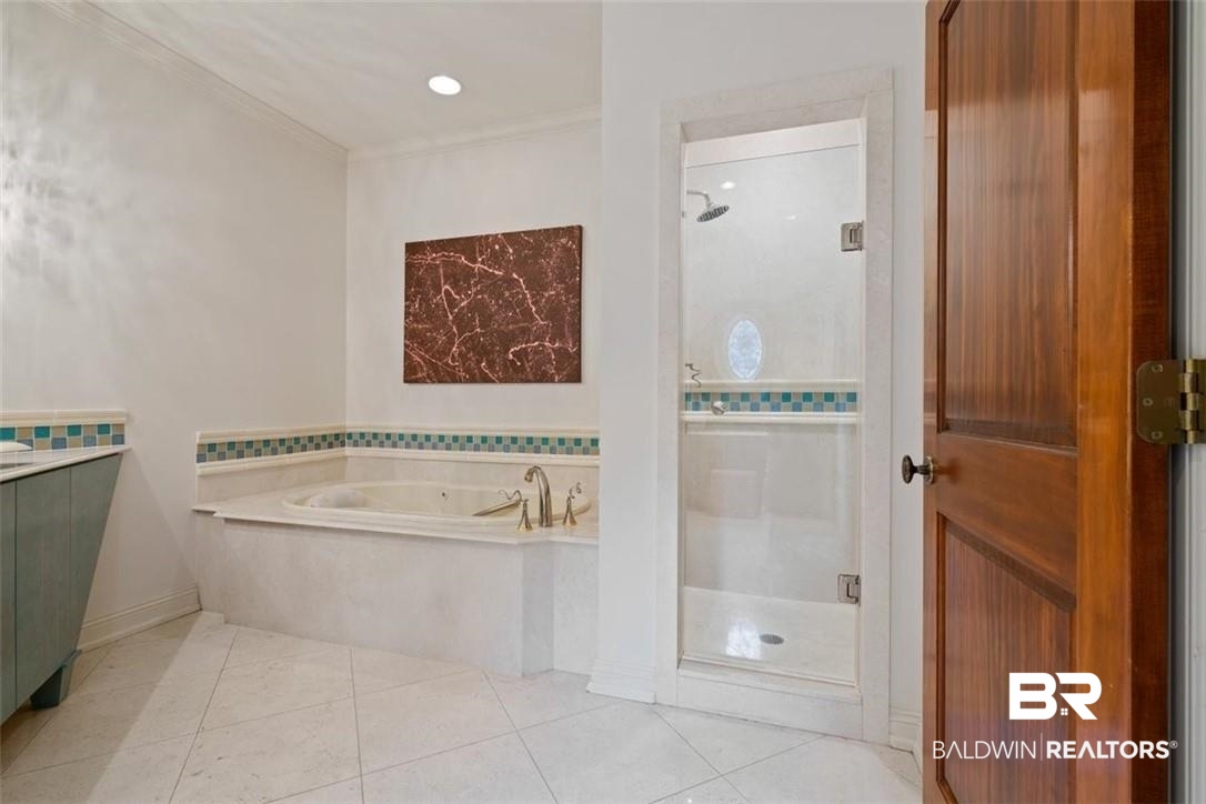 4 Chancery Court Mobile, AL 36608 - Photo 28 of 54 Bathroom featuring ornamental molding, shower with separate bathtub, tile patterned floors, and vanity