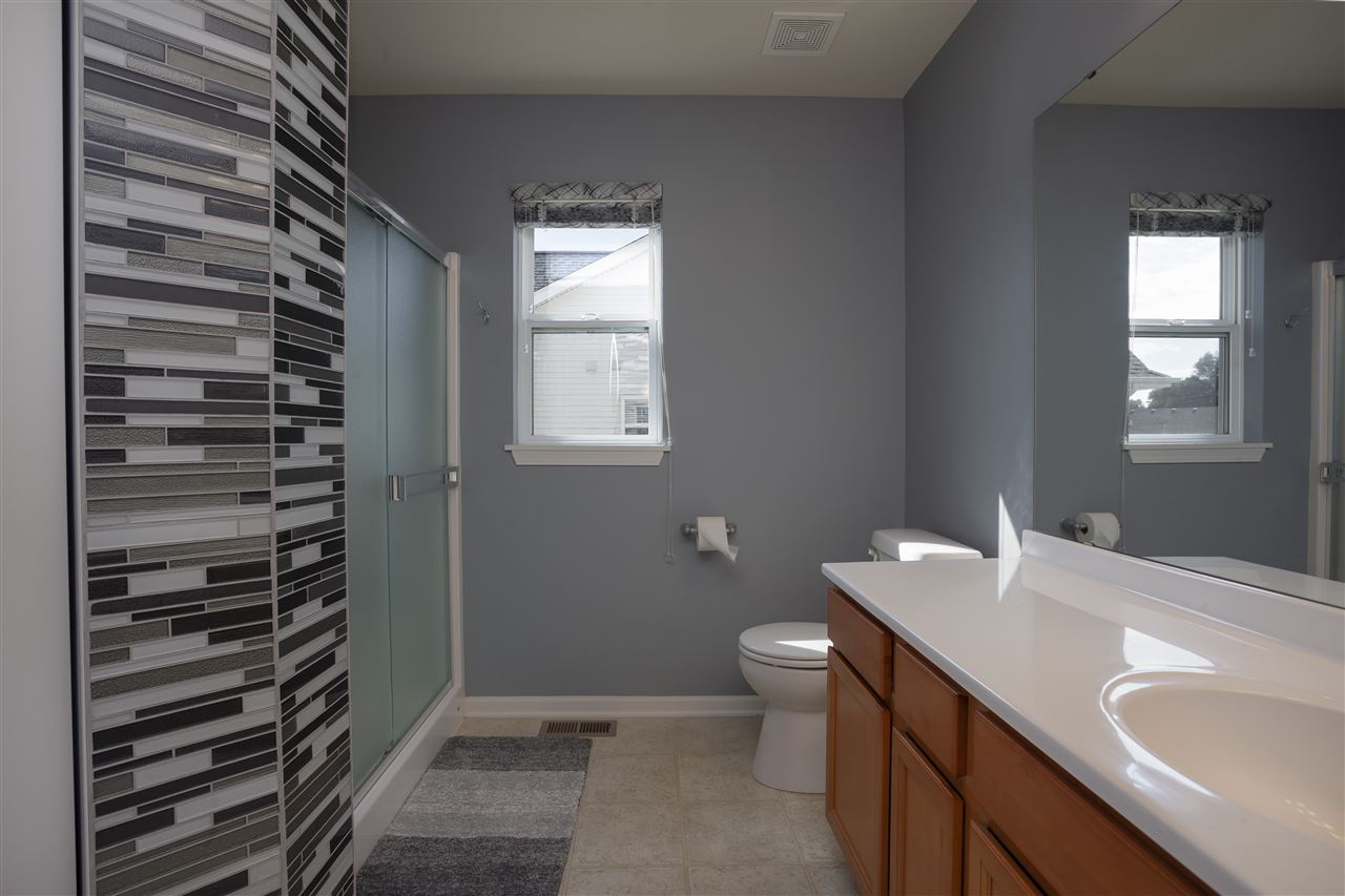 7634 Jockey Drive Loves Park, IL 61111 - Photo 11 of 25 a bathroom with a sink toilet and window