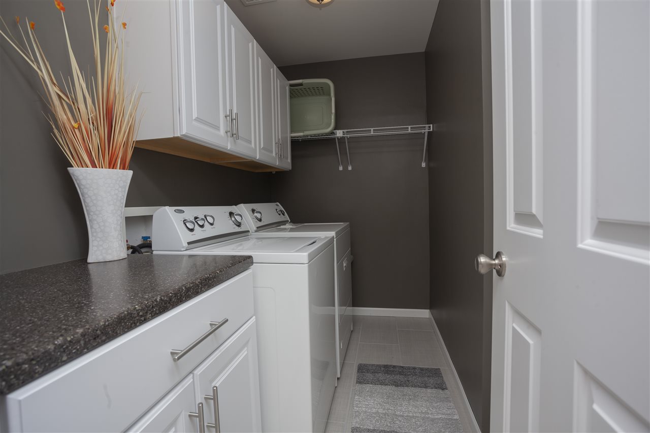 7634 Jockey Drive Loves Park, IL 61111 - Photo 14 of 25 a view of a kitchen with fridge and wooden floor