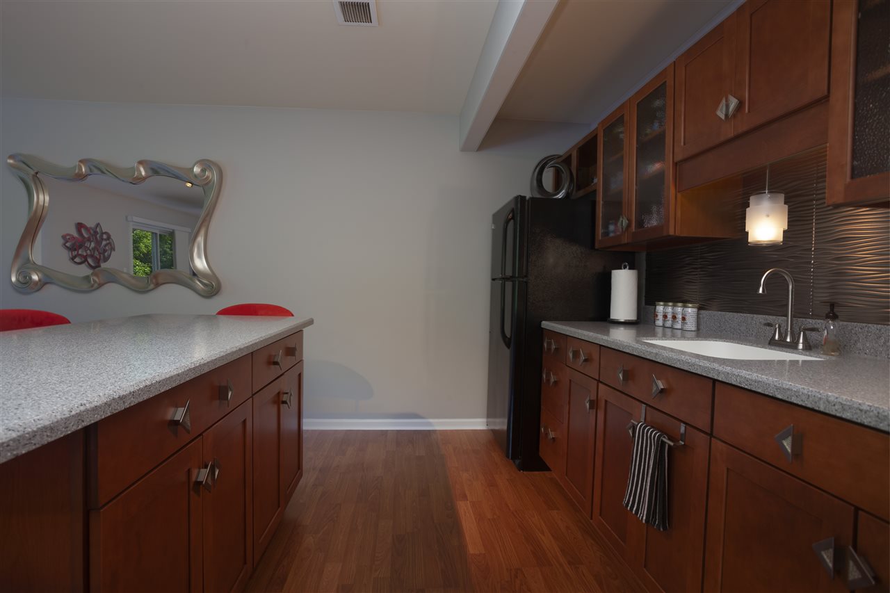 7634 Jockey Drive Loves Park, IL 61111 - Photo 21 of 25 a kitchen with a sink cabinets and wooden floor