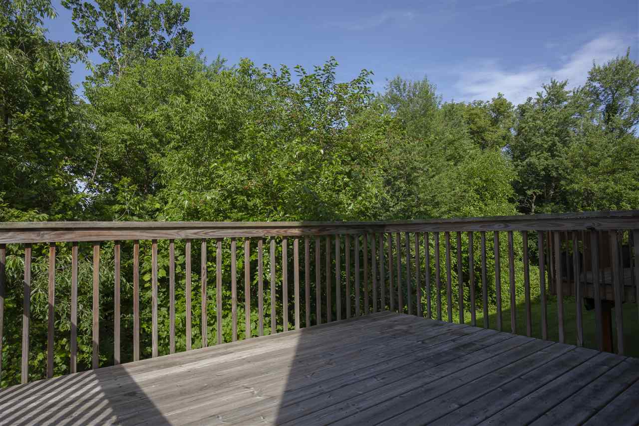 7634 Jockey Drive Loves Park, IL 61111 - Photo 24 of 25 a balcony with wooden floor and fence