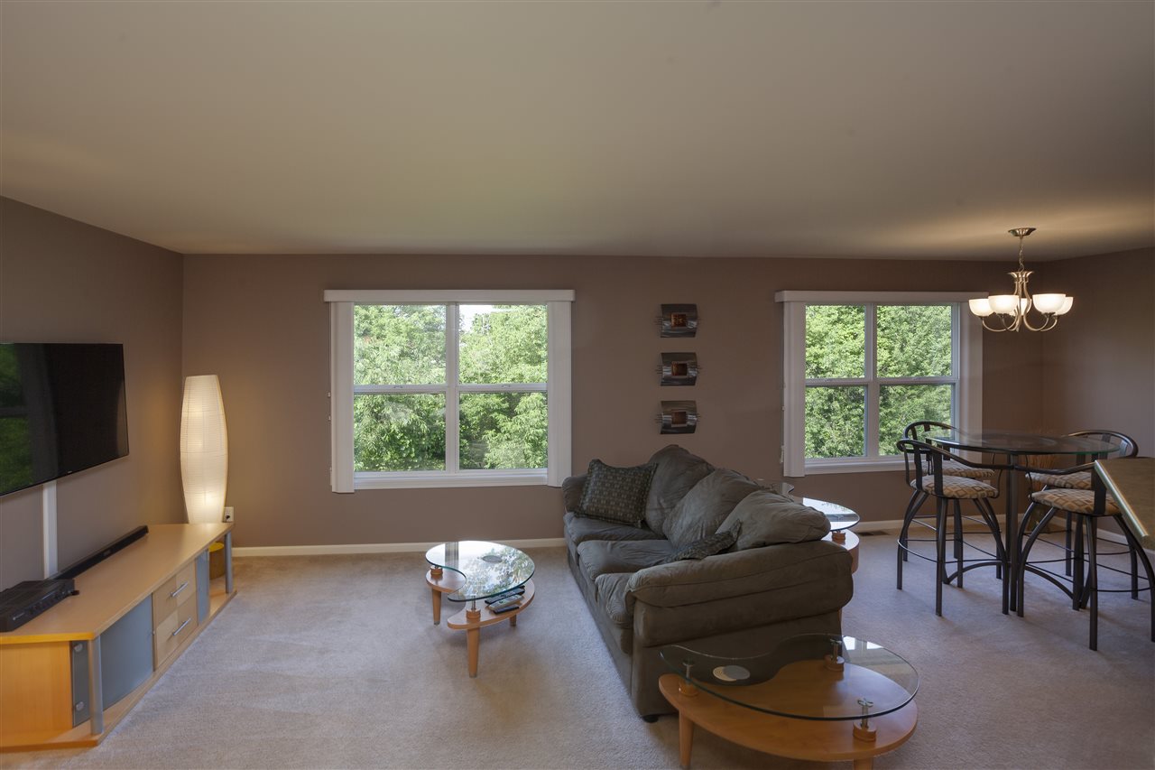 7634 Jockey Drive Loves Park, IL 61111 - Photo 3 of 25 a living room with furniture and a flat screen tv