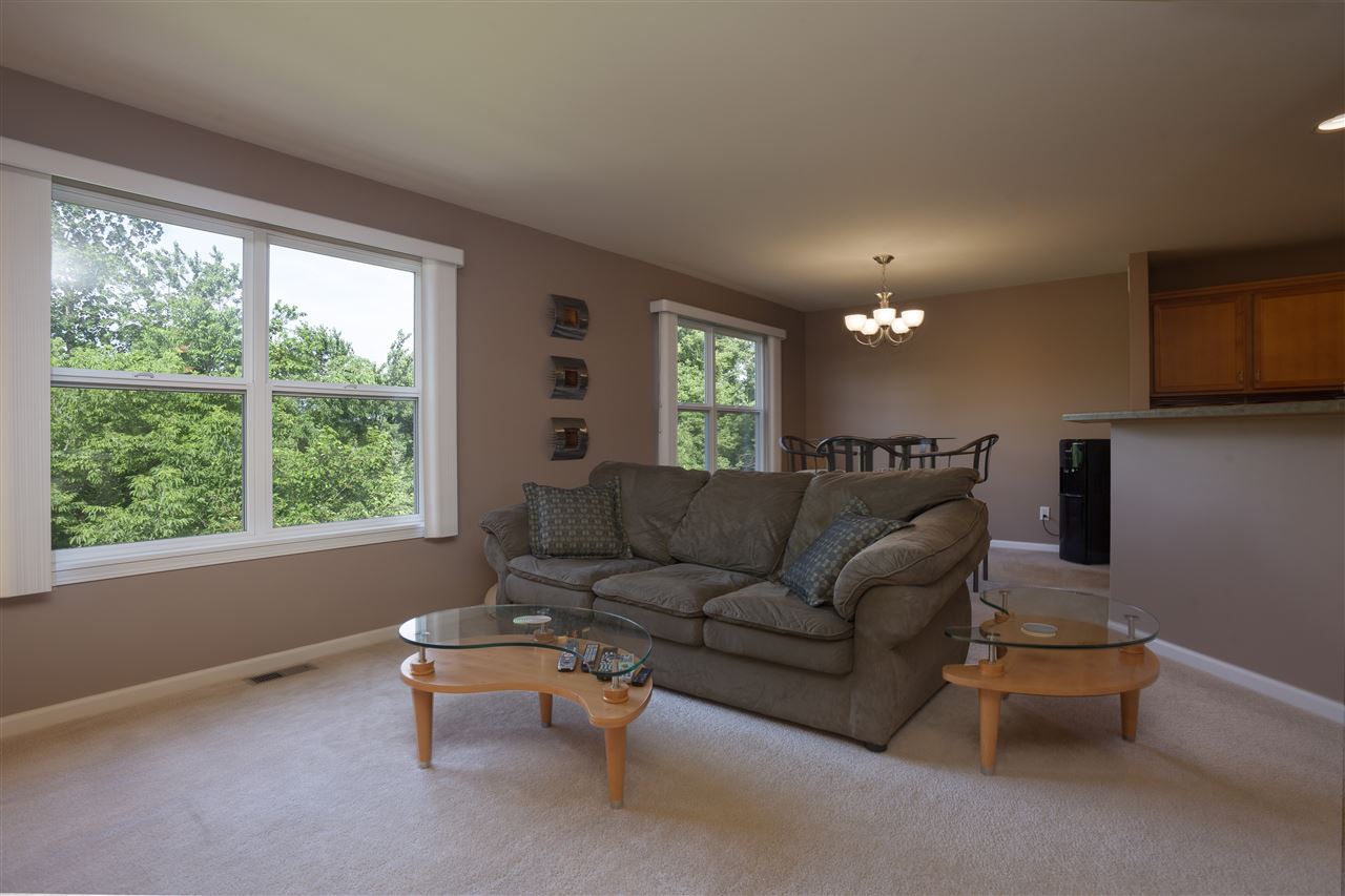 7634 Jockey Drive Loves Park, IL 61111 - Photo 4 of 25 a living room with furniture and a large window