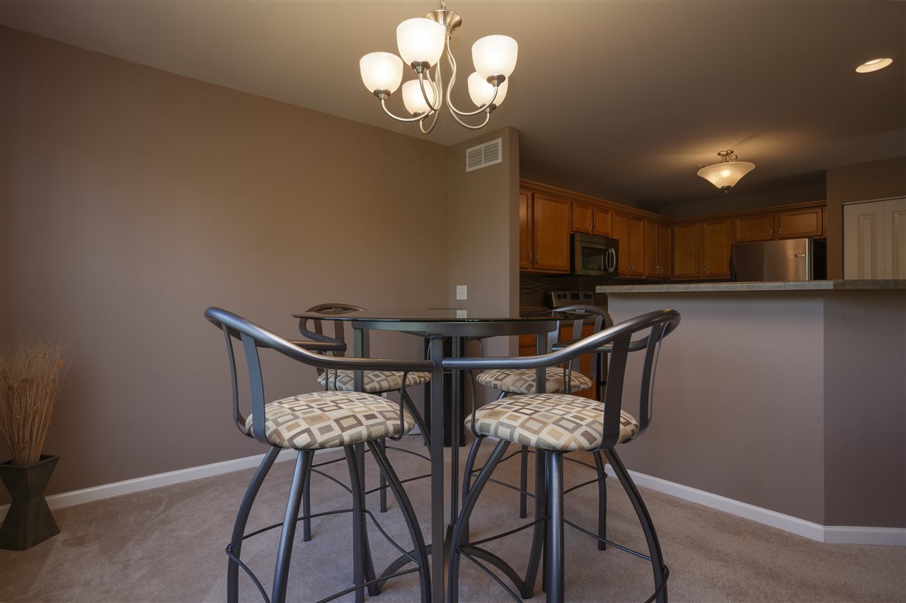 7634 Jockey Drive Loves Park, IL 61111 - Photo 5 of 25 a view of a dining room with furniture and chandelier