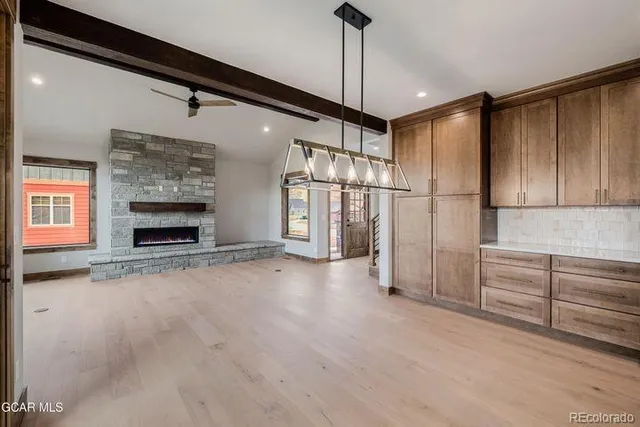 a view of an empty room with a fireplace and a yard