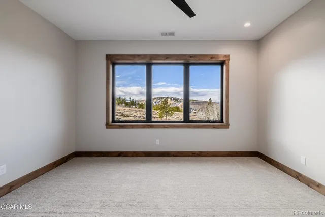 an empty room with windows and closet
