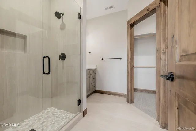 a view of an empty room with a fireplace and a window
