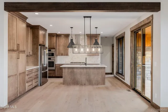 a view of a livingroom with a fireplace and windows