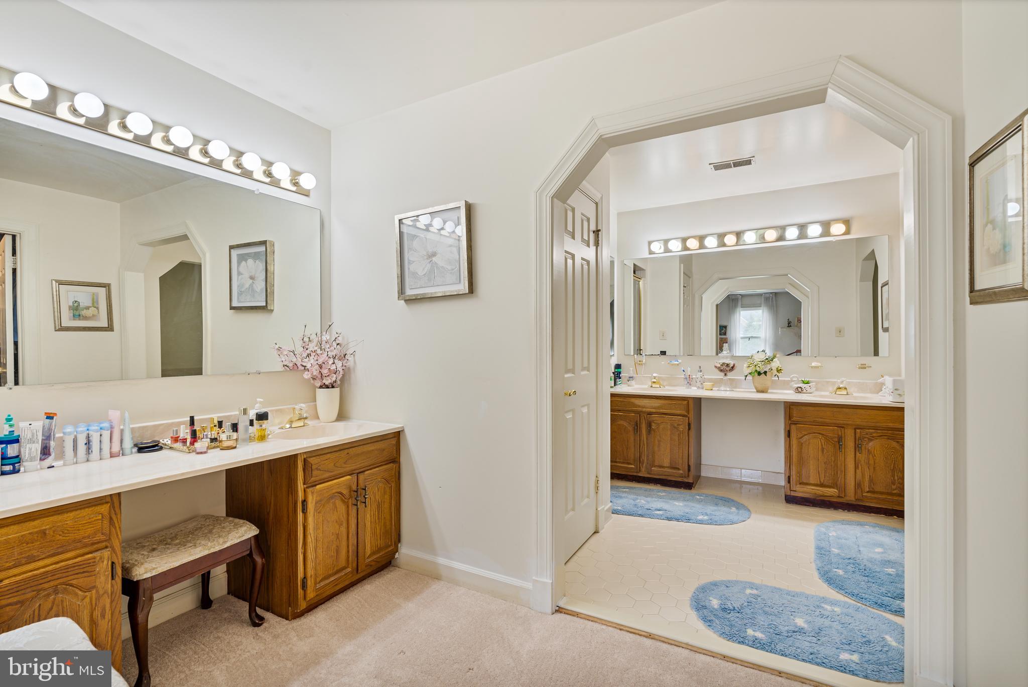 15008 Notley Road Silver Spring, MD 20905 - Photo 23 of 48 a bathroom with a granite countertop sink mirror and vanity