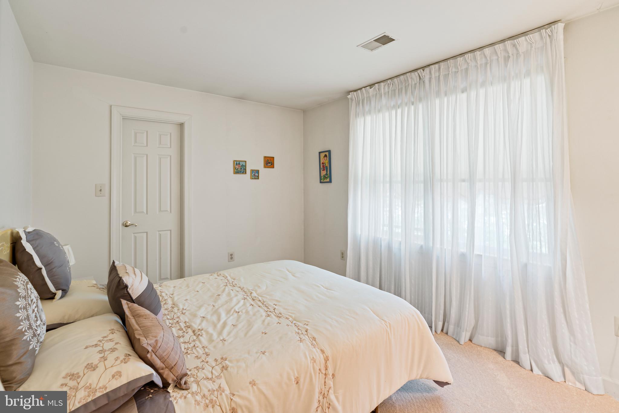 15008 Notley Road Silver Spring, MD 20905 - Photo 29 of 48 a bedroom with a bed and a chair