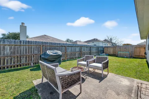 a view of a chairs and table in the yard