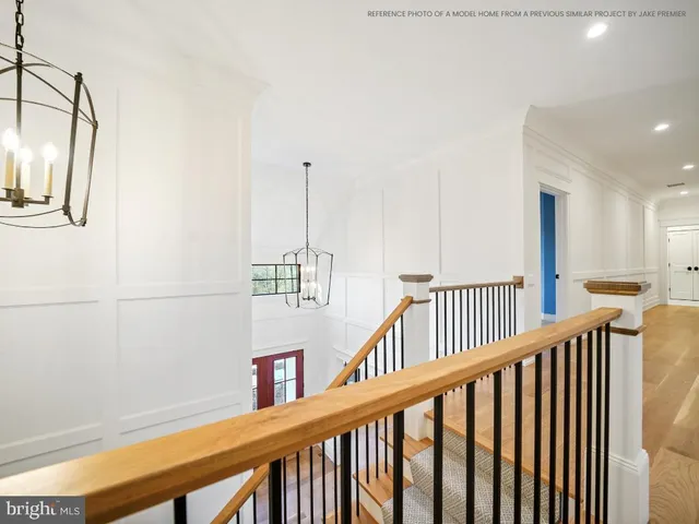a view of staircase with railing and wooden floor
