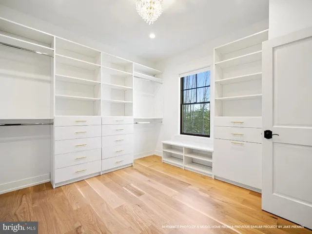 a view of a room with wooden floor and cabinet