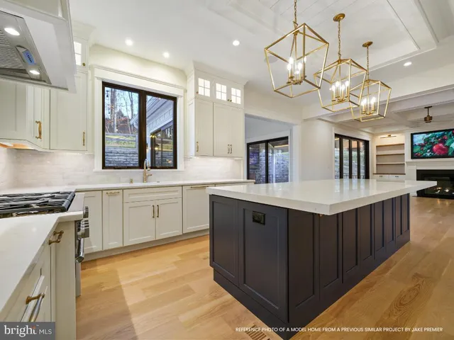 a kitchen with stainless steel appliances granite countertop a sink a stove top oven a counter space and cabinets