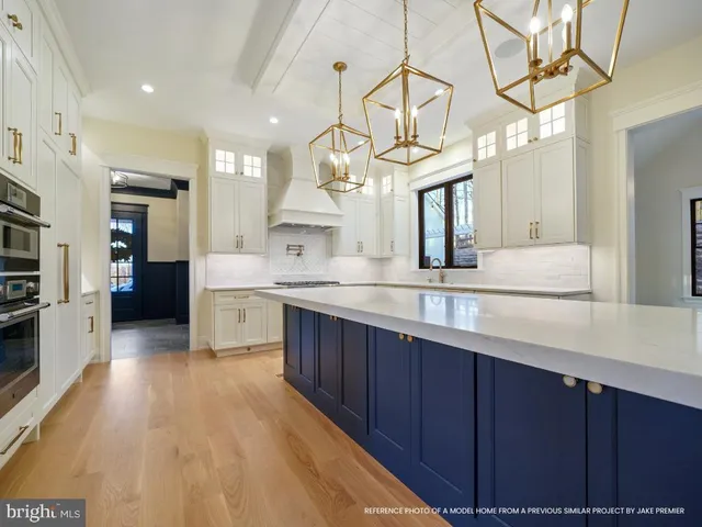 a large kitchen with stainless steel appliances a counter space a sink and cabinets