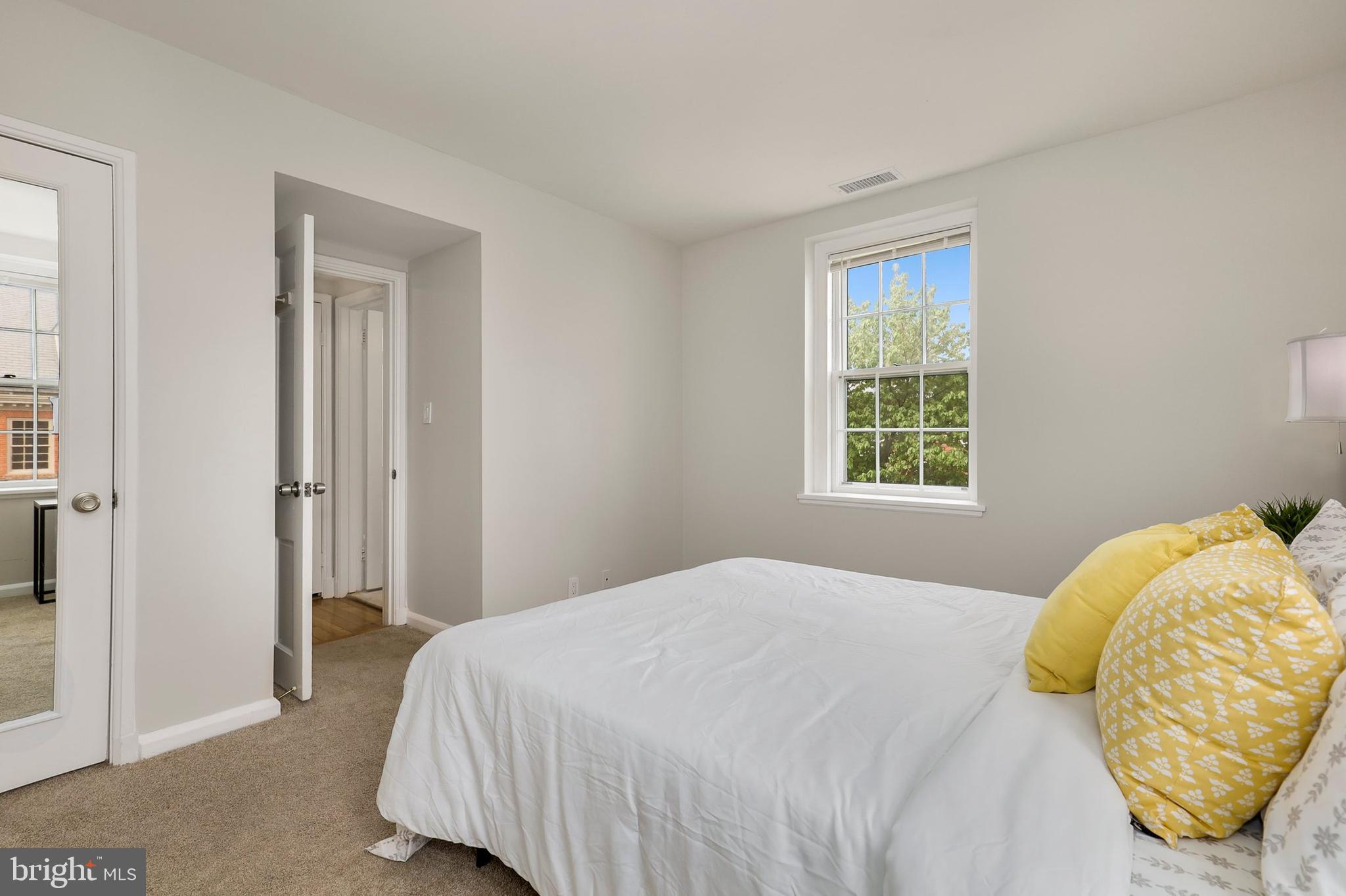 3831 Rodman Street Northwest, Unit F30 Washington, DC 20016 - Photo 19 of 33 a bedroom with a bed and a window