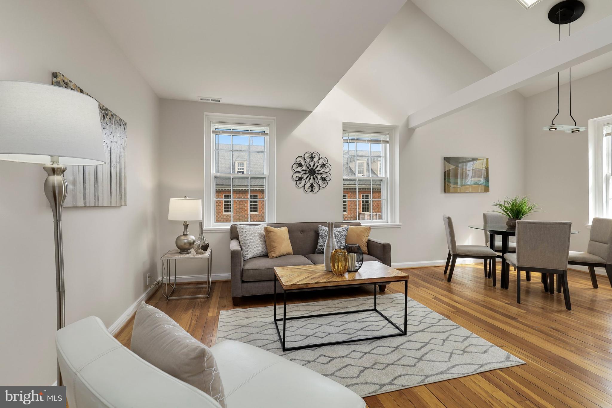 3831 Rodman Street Northwest, Unit F30 Washington, DC 20016 - Photo 3 of 33 a living room with furniture and wooden floor