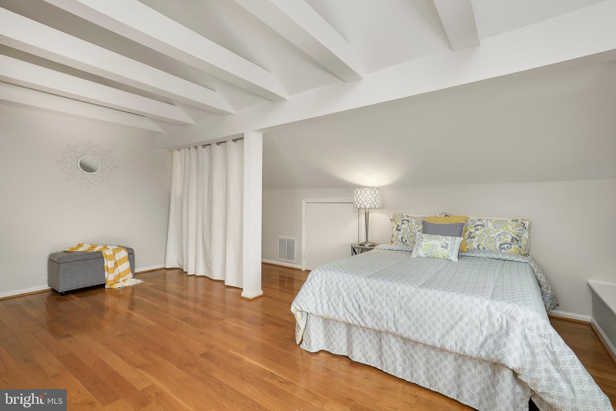 3831 Rodman Street Northwest, Unit F30 Washington, DC 20016 - Photo 28 of 33 a bedroom with a bed and chair